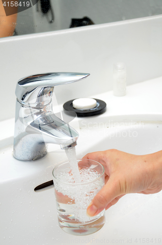 Image of Filling a glass with water