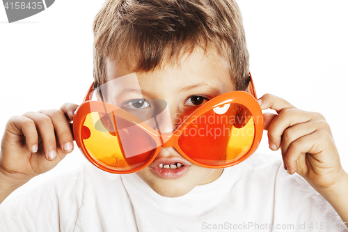 Image of little cute boy in orange sunglasses pointing isolated close up 