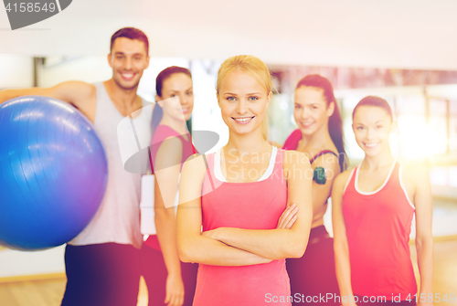 Image of woman standing in front of the group in gym