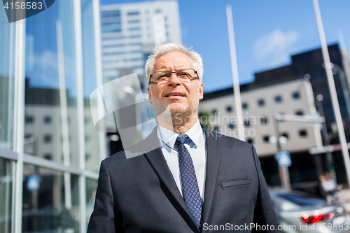 Image of senior businessman on city street