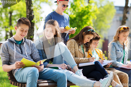 Image of group of students with notebooks at school yard