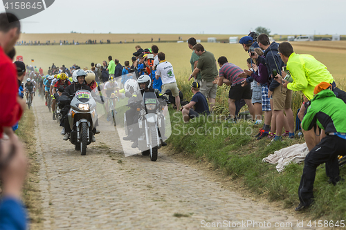 Image of The Peloton on a Cobblestone Road - Tour de France 2015