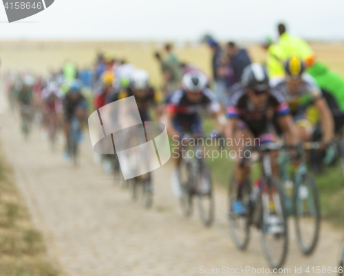 Image of The Peloton on a Cobblestone Road - Tour de France 2015