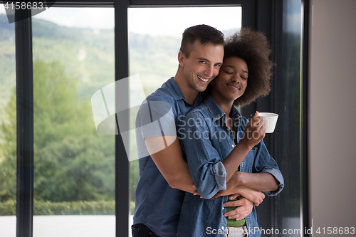 Image of romantic happy young couple relax at modern home indoors