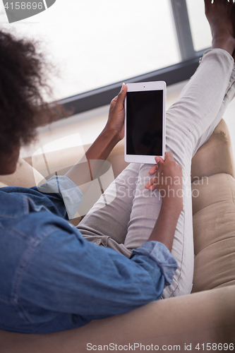 Image of african american woman at home with digital tablet