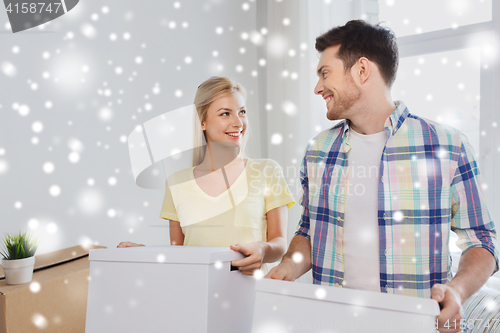 Image of smiling couple with big boxes moving to new home