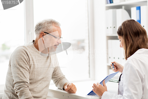 Image of senior man and doctor meeting at hospital