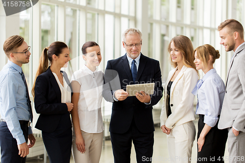 Image of business people with tablet pc computer at office