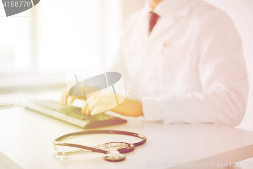 Image of male doctor typing on the keyboard