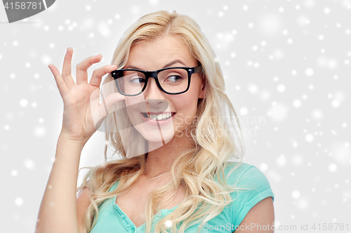 Image of happy young woman or teenage girl in glasses