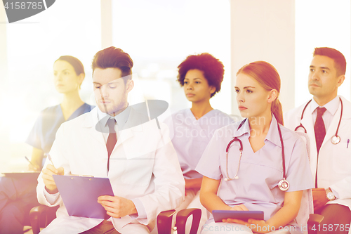 Image of group of happy doctors on seminar at hospital