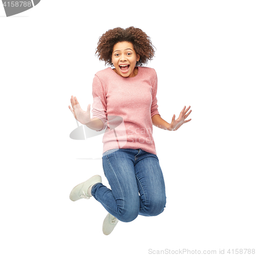 Image of happy african american woman jumping over white