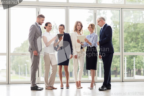 Image of business people with tablet pc computers at office