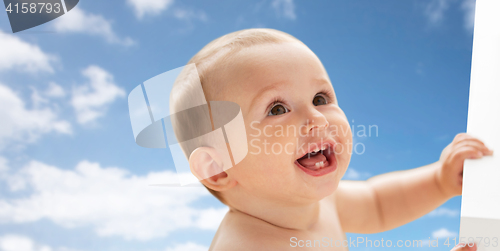 Image of happy little baby boy or girl looking up