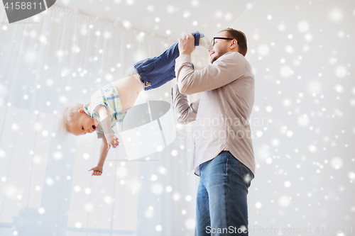 Image of father with son playing and having fun at home