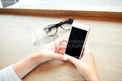 Image of close up of woman texting on smartphone