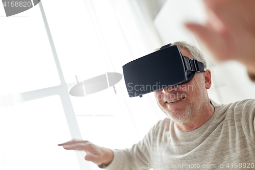 Image of old man in virtual reality headset or 3d glasses