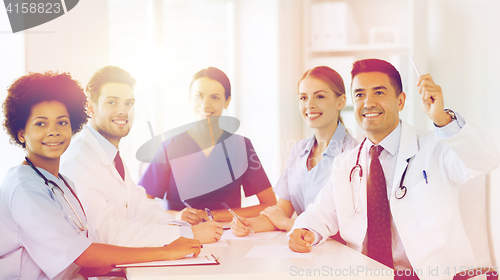 Image of group of happy doctors on conference at hospital