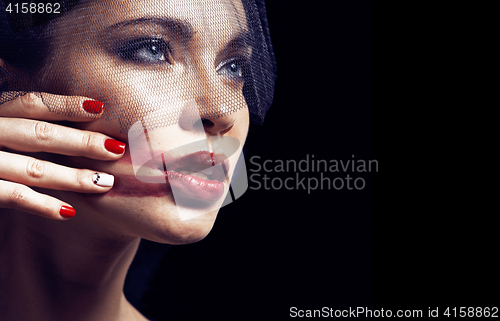 Image of beauty brunette woman under black veil with red manicure close u