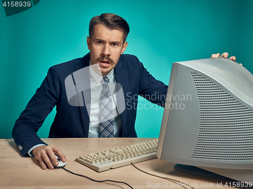 Image of Surprised Young Man Working On computer At Desk