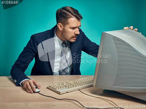 Image of Surprised Young Man Working On computer At Desk