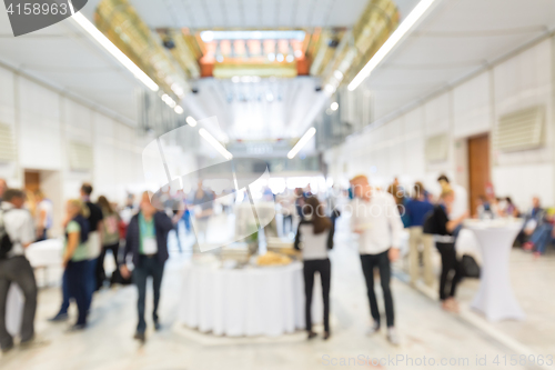 Image of Abstract blurred people socializing during lunch break at business conference.