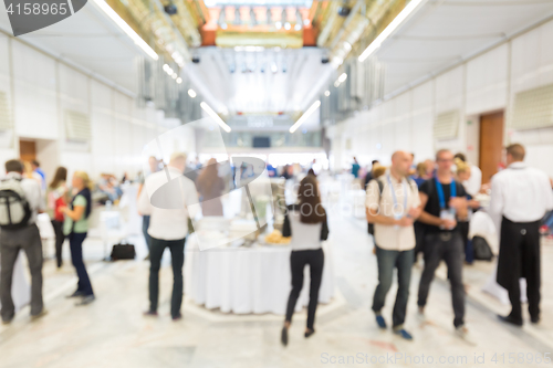 Image of Abstract blurred people socializing during lunch break at business conference.