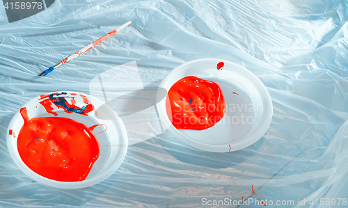 Image of Red Paint In Plastic Plates