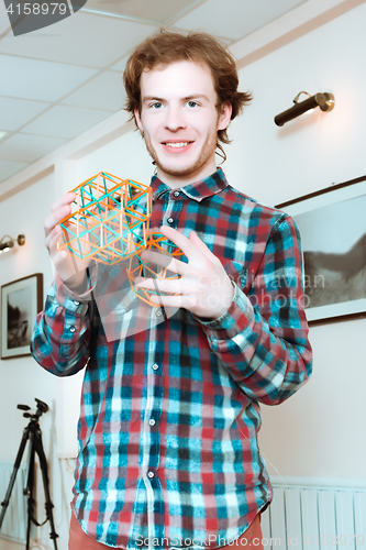 Image of Young Man With Volumetric Models Of Geometric Solids