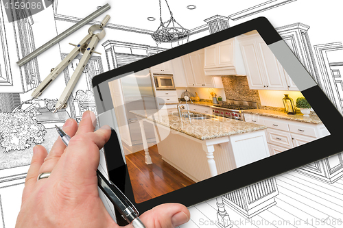 Image of Hand on Computer Tablet Showing Photo of Kitchen Drawing Behind 