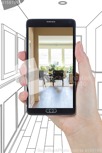 Image of Hand Holding Smart Phone Displaying Photo of House Hallway Drawi