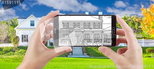 Image of Hands Holding Smart Phone Displaying Drawing of Home Photo Behin