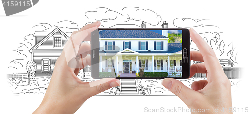 Image of Hands Holding Smart Phone Displaying Home Photo of Drawing Behin