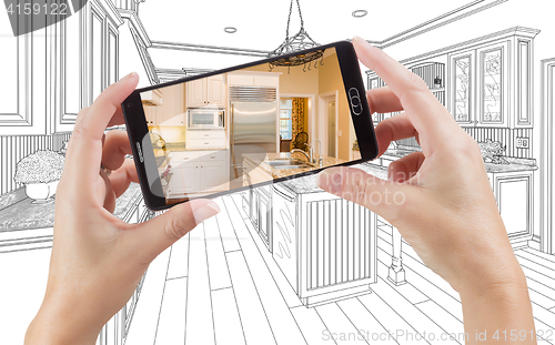 Image of Hands Holding Smart Phone Displaying Photo of Kitchen Drawing Be