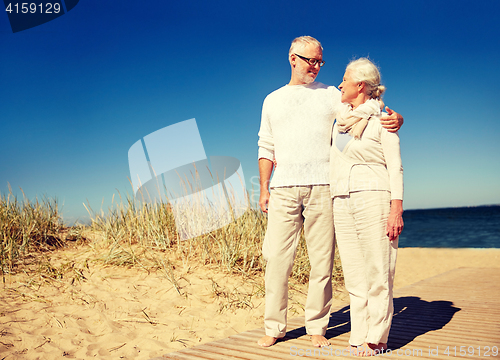 Image of happy senior couple talking outdoors