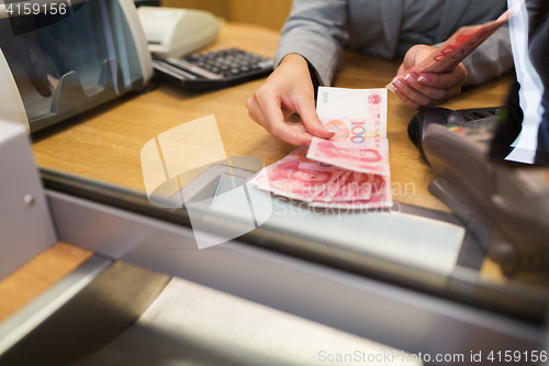 Image of clerk counting cash money at bank office