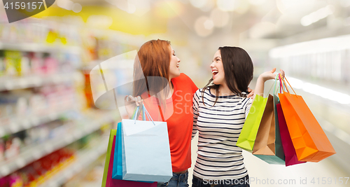 Image of teenage girls with shopping bags and credit card