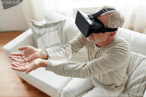 Image of old man in virtual reality headset or 3d glasses