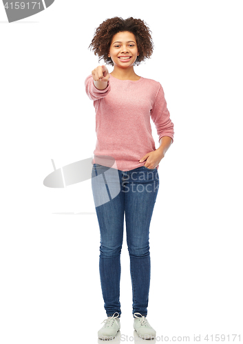 Image of happy african woman pointing finger on you