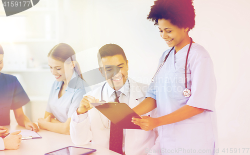 Image of group of happy doctors meeting at hospital office