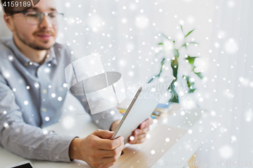 Image of happy creative male office worker with tablet pc