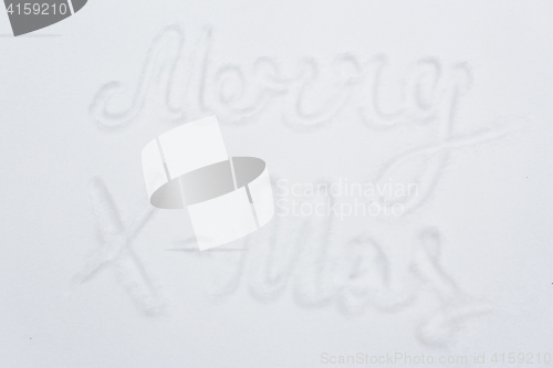 Image of merry christmas words on snow surface