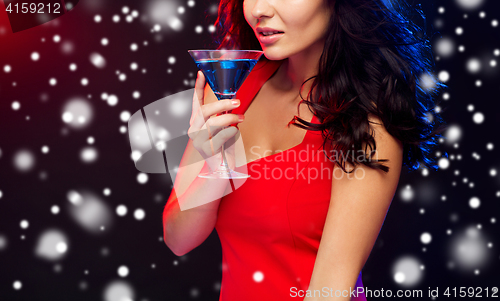 Image of close up of beautiful woman with cocktail at night