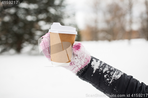 Image of close up of hand with coffee outdoors in winter