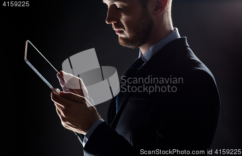 Image of close up of businessman with transparent tablet pc