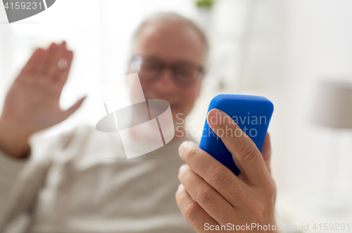 Image of close up of man having video call on smartphone