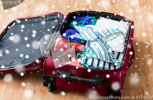 Image of close up of travel bag with beach clothes