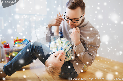 Image of father with son playing and having fun at home