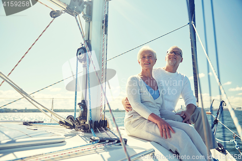 Image of senior couple hugging on sail boat or yacht in sea