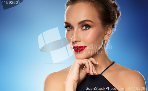 Image of beautiful woman in black over blue background